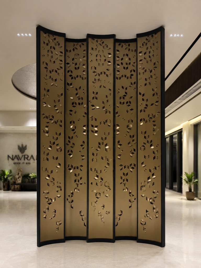 Front center view of a custom laser-cut decorative metal feature screen installed at the Navraj Builders project on Dwarka Expressway.