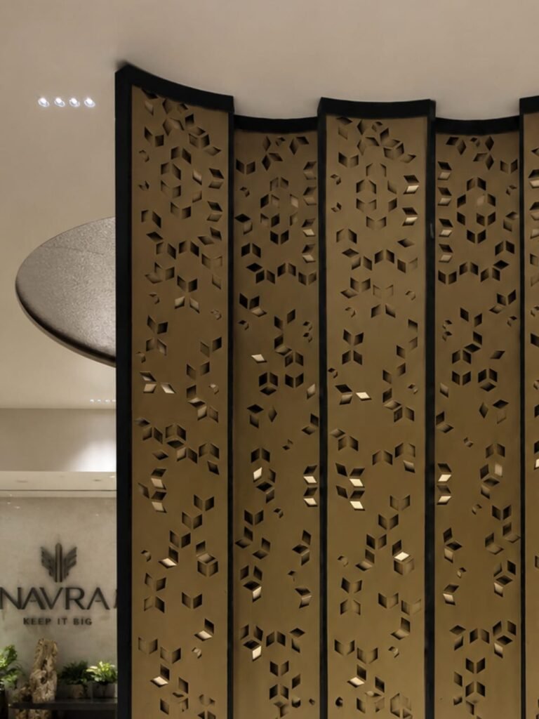 Front center view of a custom laser-cut decorative metal feature screen installed at the Navraj Builders project on Dwarka Expressway.