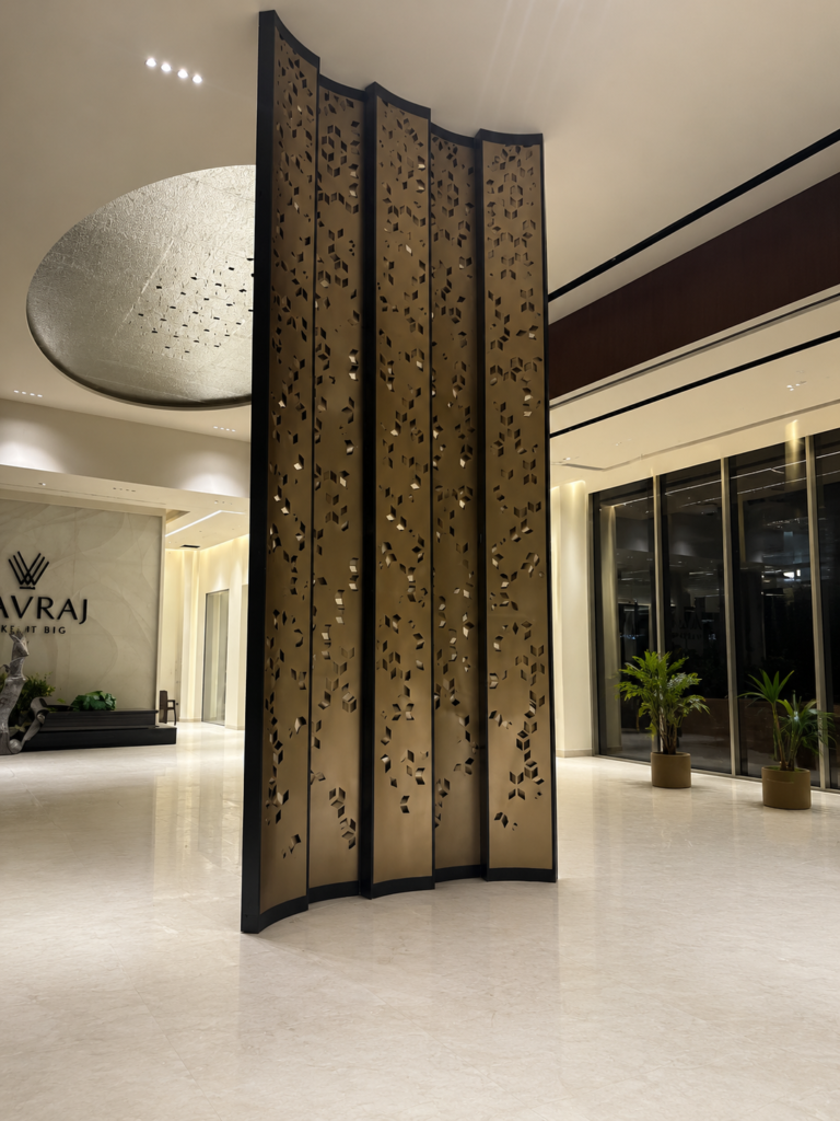 Custom decorative metal feature screen installation at Navraj Builders, Dwarka Expressway with premium laser-cut architectural metal panels.