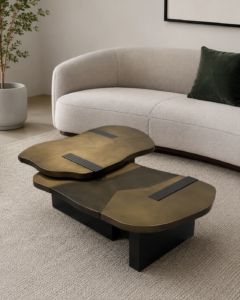 Optimized Alt Text: Luxury tiered cocktail table named Tectonic, featuring a hand-rubbed burnished brass segmented top with matte black geometric inlays in a modern living room setting.