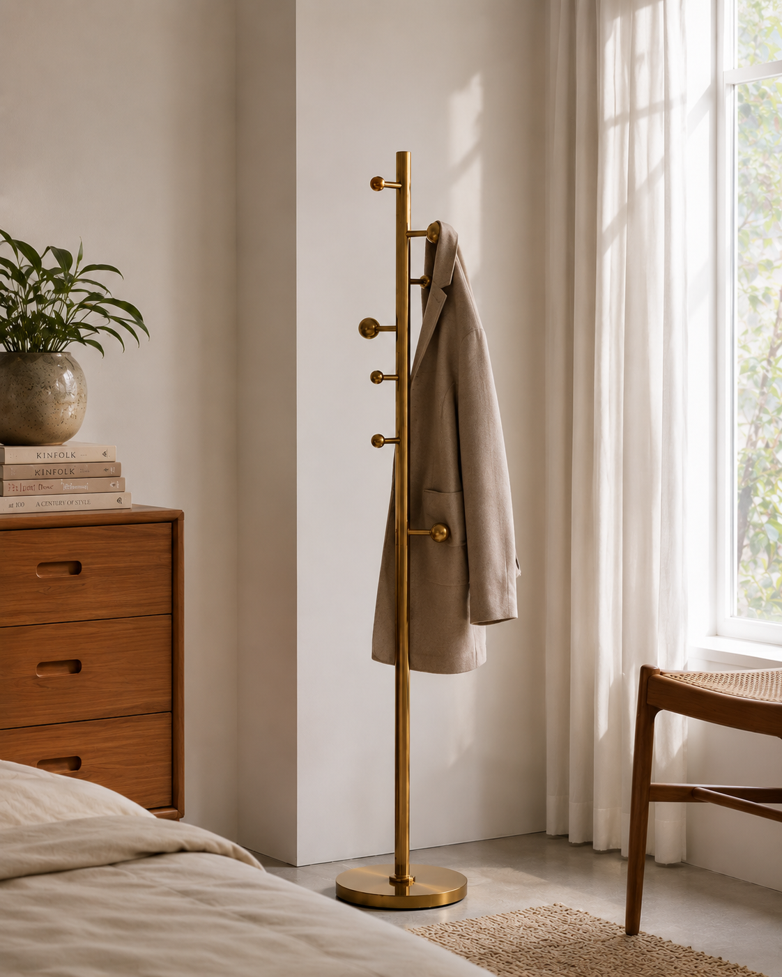 Modern Brass Floor Coat Stand for Bedroom & Entryway Modern brushed brass freestanding coat stand with multiple hooks in a minimalist bedroom interior.