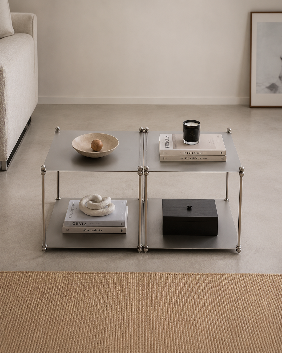 Two-Tier Modular Coffee Table with Sculptural Metal Legs Front view of a gunmetal two-tier modular coffee table with silver ball-joint legs, styled with a ceramic bowl, stacked books, candle, and a black lidded box
