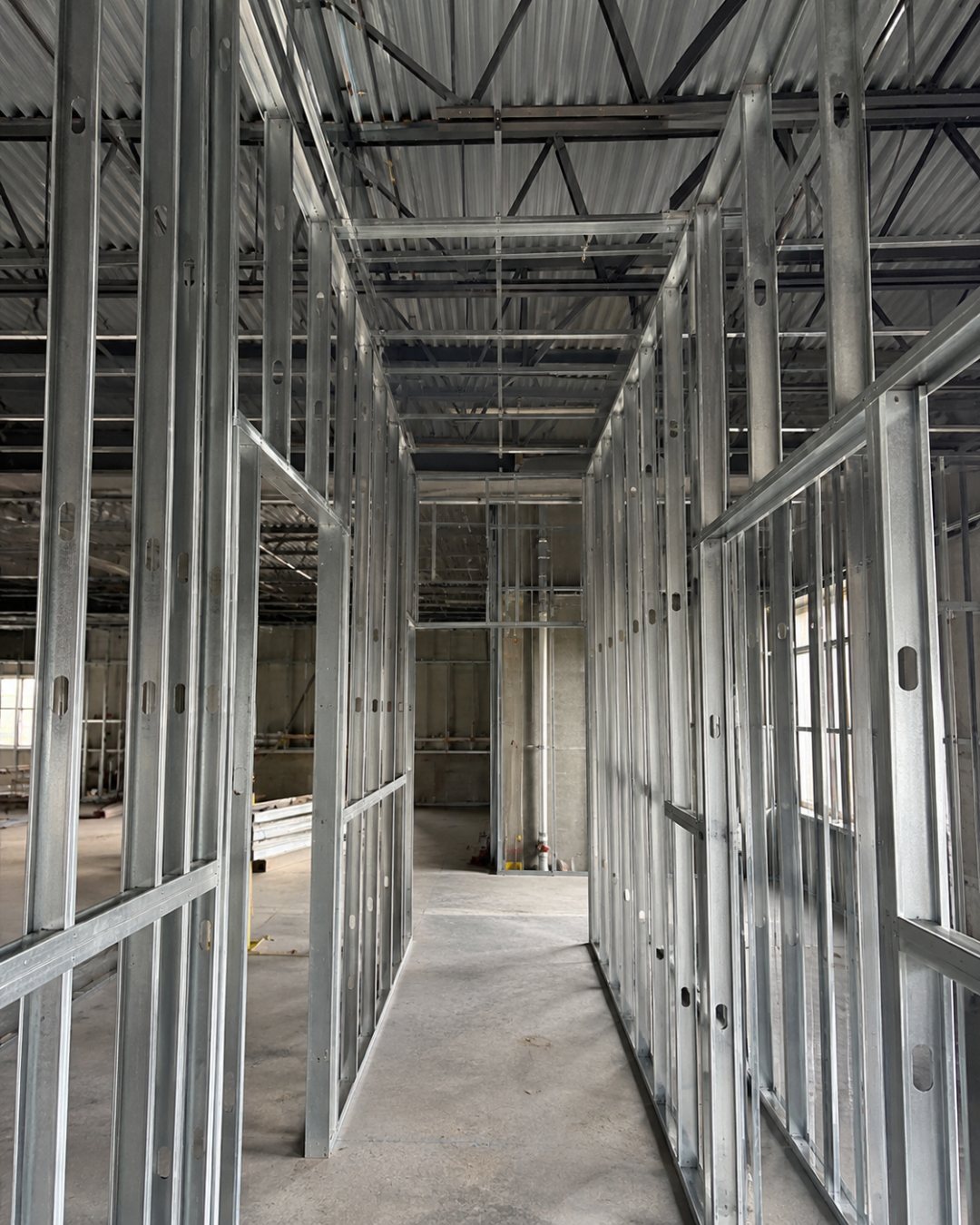 Ultra-realistic premium metal framing and architectural metal work installed at a modern real estate development site.